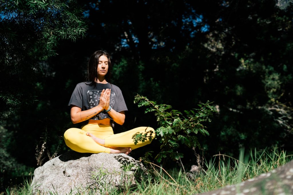 woman in yoga outfit meditating